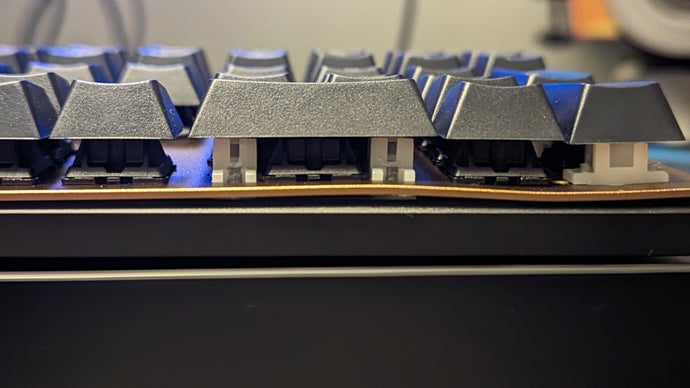 cherry kc 200 mx keyboard with a visible bend in its metal plate under the numpad's zero key.