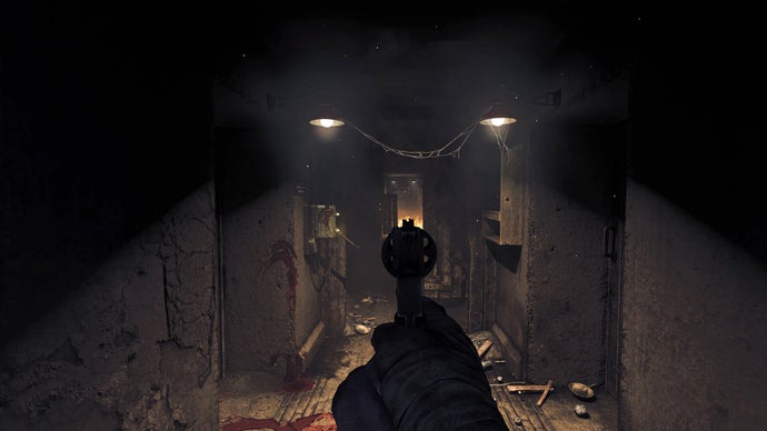 The player aiming a pistol down a corridor at an unseen creature in Amnesia: The Bunker.