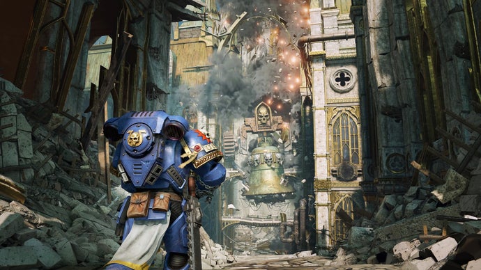 A blue-coloured Space Marine walks towards a huge, towering - and crumbling - building ahead of them.