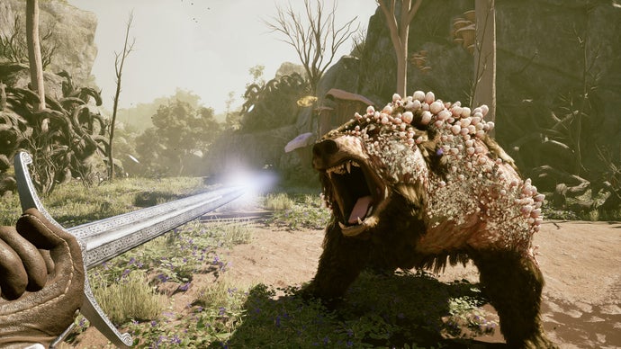 A first-person perspective of a character holding a sword fighting a bear which has crystals growing out of its head and back.