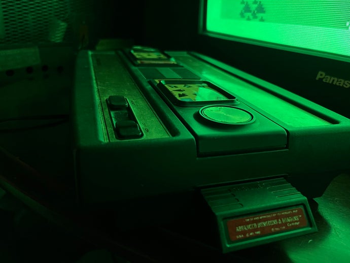 A picture of Mattel's Intellivision console, reflecting light from a television.