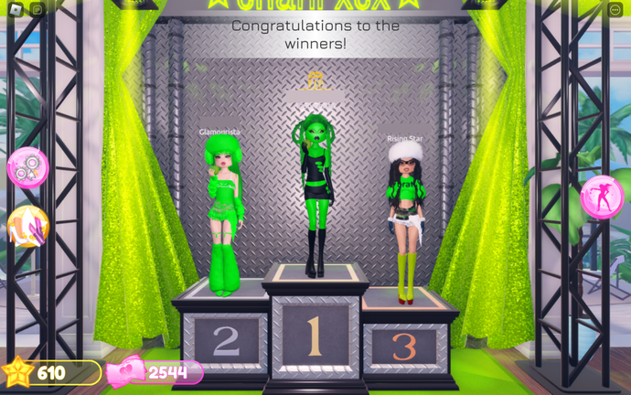 A podium finish for the theme 'Brat' in dress to impress.  The players are all women dressed in bright green outfits. The winner has green skin, holds an apple, and is wearing a cut-out black dress.