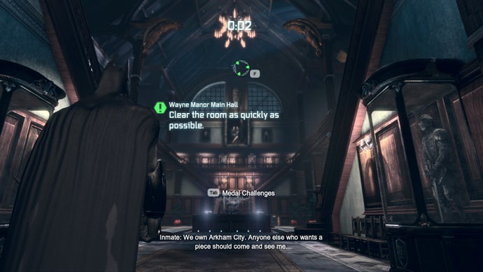 The main foyer of Wayne Manor in Batman Arkham City. Text reads "Clear the room as quickly as possible."