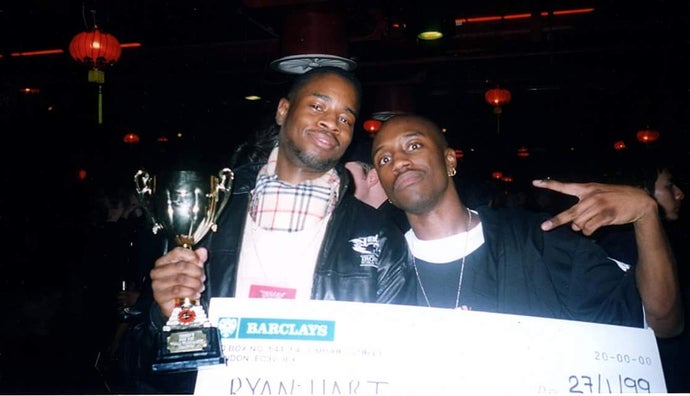 Photo scan of Ryan Hart and friend with his trophy from winning a tournament, and oversized cheque, dated 1999.