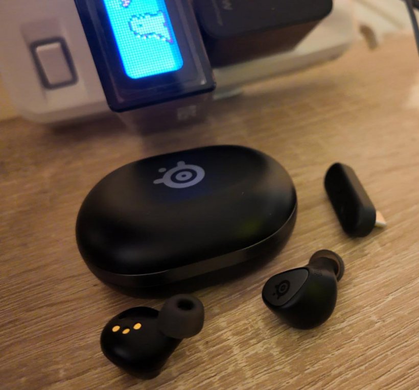 steelseries arctis gamebuds with the case closed and the earbuds on a table