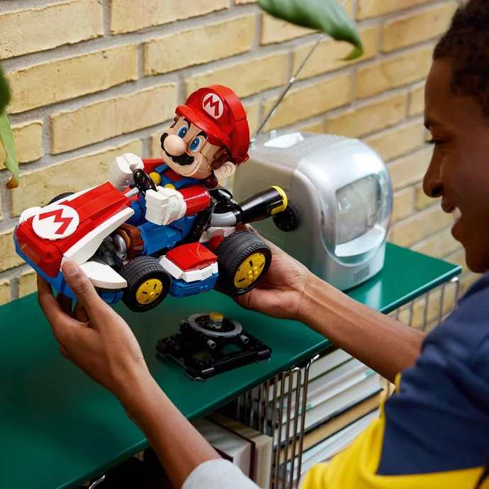 Mario Kart Lego set being placed on a stand