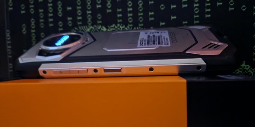 DOOGEE S200 lying on its orange and black box with side buttons and mech-designed back showing