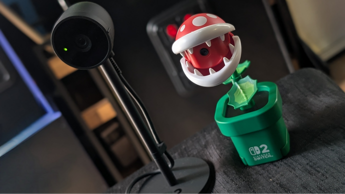 The official Nintendo Switch 2 USB camera stood next to the Hori Piranha Plant camera, which looks like a colourful plastic Piranha Plant.