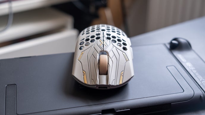 finalmouse ulx prophecy gaming mouse, viewed from the front with golden accents and mouse wheel showing