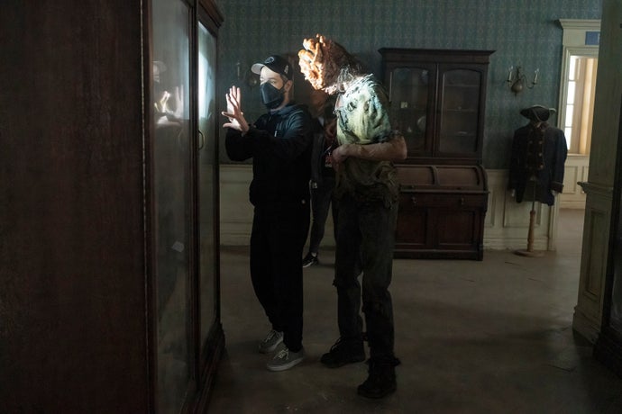 Neil Druckmann on the set of the first season of The Last of Us. He is giving direction to a person in character as a Clicker