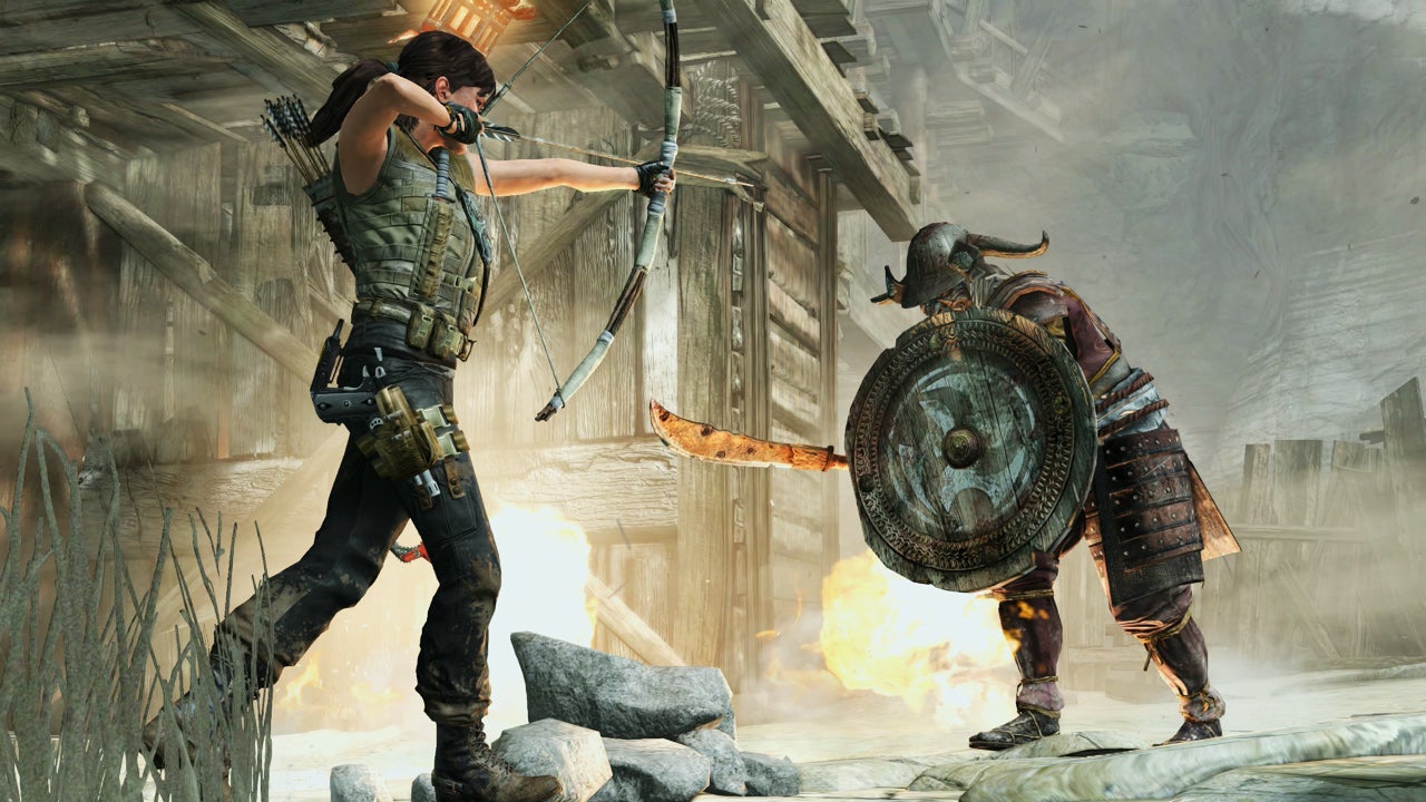 Lara aims an arrow at an advancing enemy in Tomb Raider Definitive Edition